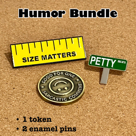Three products sitting on a cork board: a yellow enamel pin made to look like a ruler that says SIZE MATTERS, an enamel pin made to look like a green street sign that says PETTY BLVD, and a coin made to look like a subway fare token that says GOOD FOR ONE SARCASTIC COMMENT.