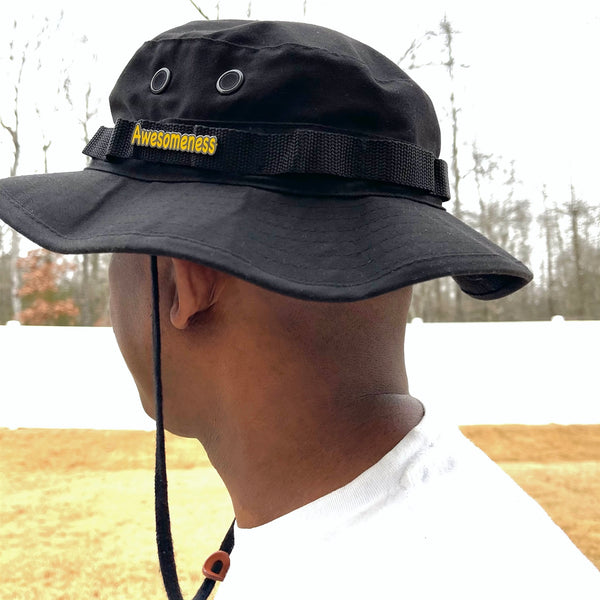 Yellow Awesomeness enamel pin on a black hat