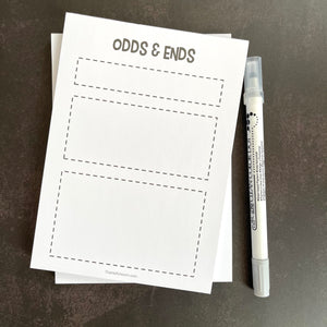 Odds and Ends Notepad has three different sized boxed off areas in small, medium, large. White paper with black lettering.
