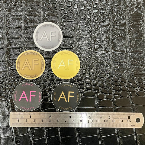 Five As F**k Token Stickers in various colors. A ruler sits at the bottom to help with sizing.